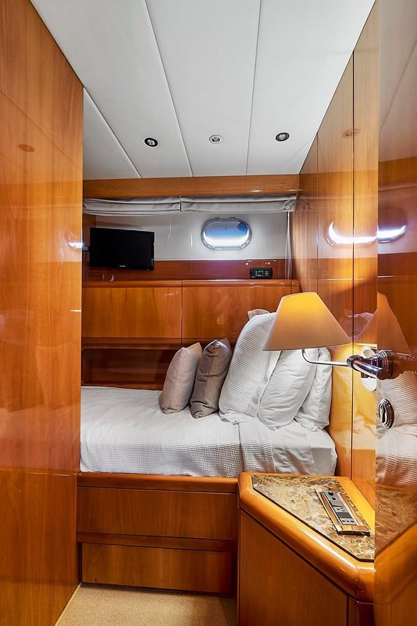 a room with a bed and a television aboard HAKUNA MATATA Yacht for Sale