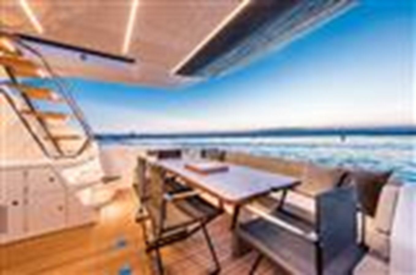 a room with a table and chairs aboard FERRETTI YACHTS 670  Yacht for Sale