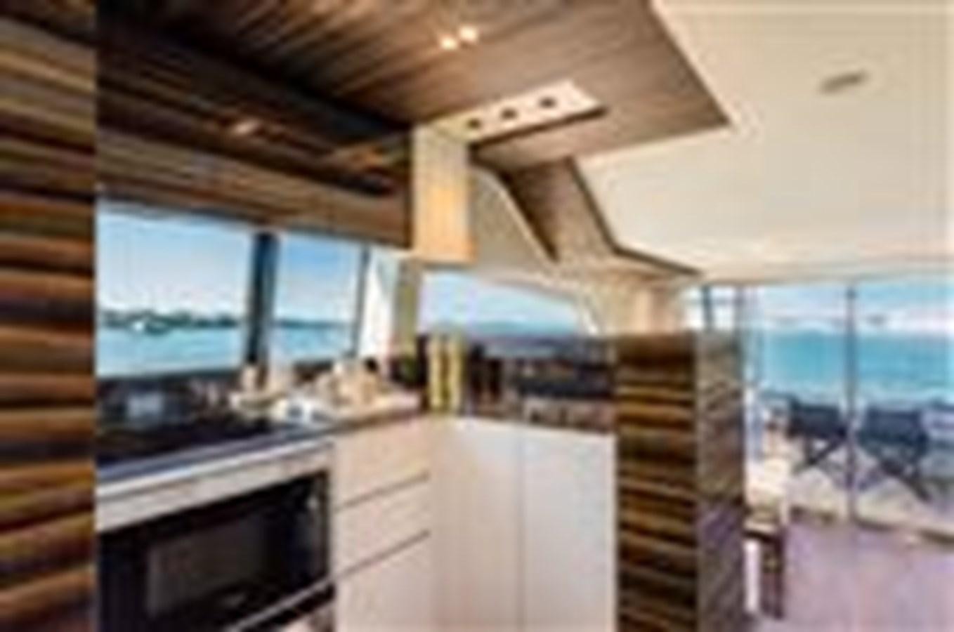 a kitchen with a wood staircase aboard FERRETTI YACHTS 670  Yacht for Sale