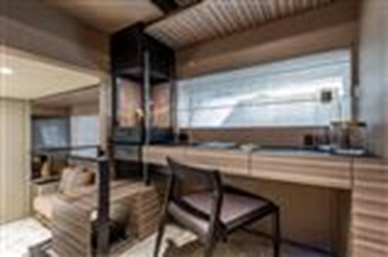 a room with a table and chairs aboard FERRETTI YACHTS 670  Yacht for Sale
