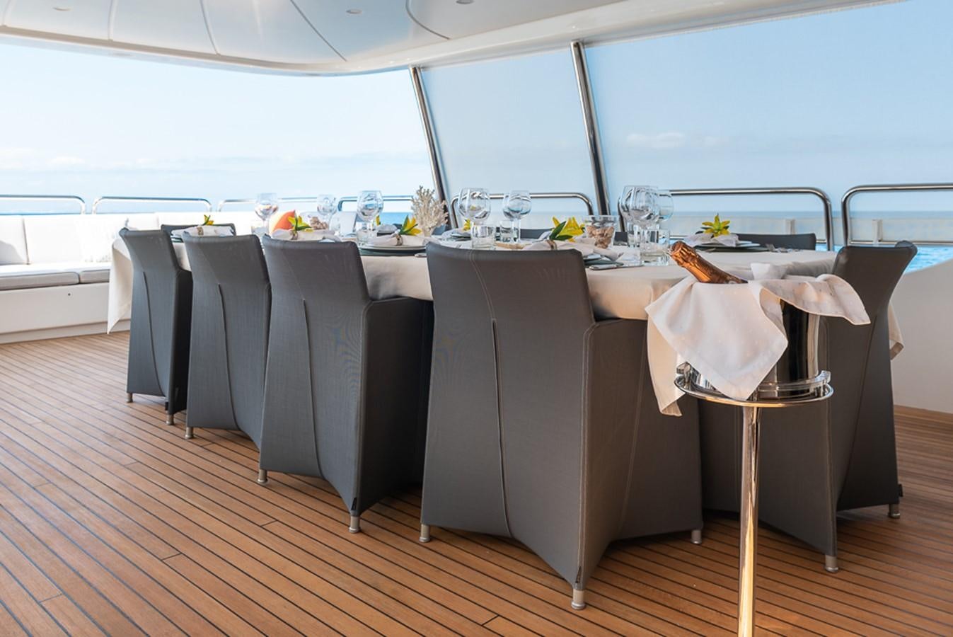 a room with a table and chairs aboard ELENA NUEVE Yacht for Charter