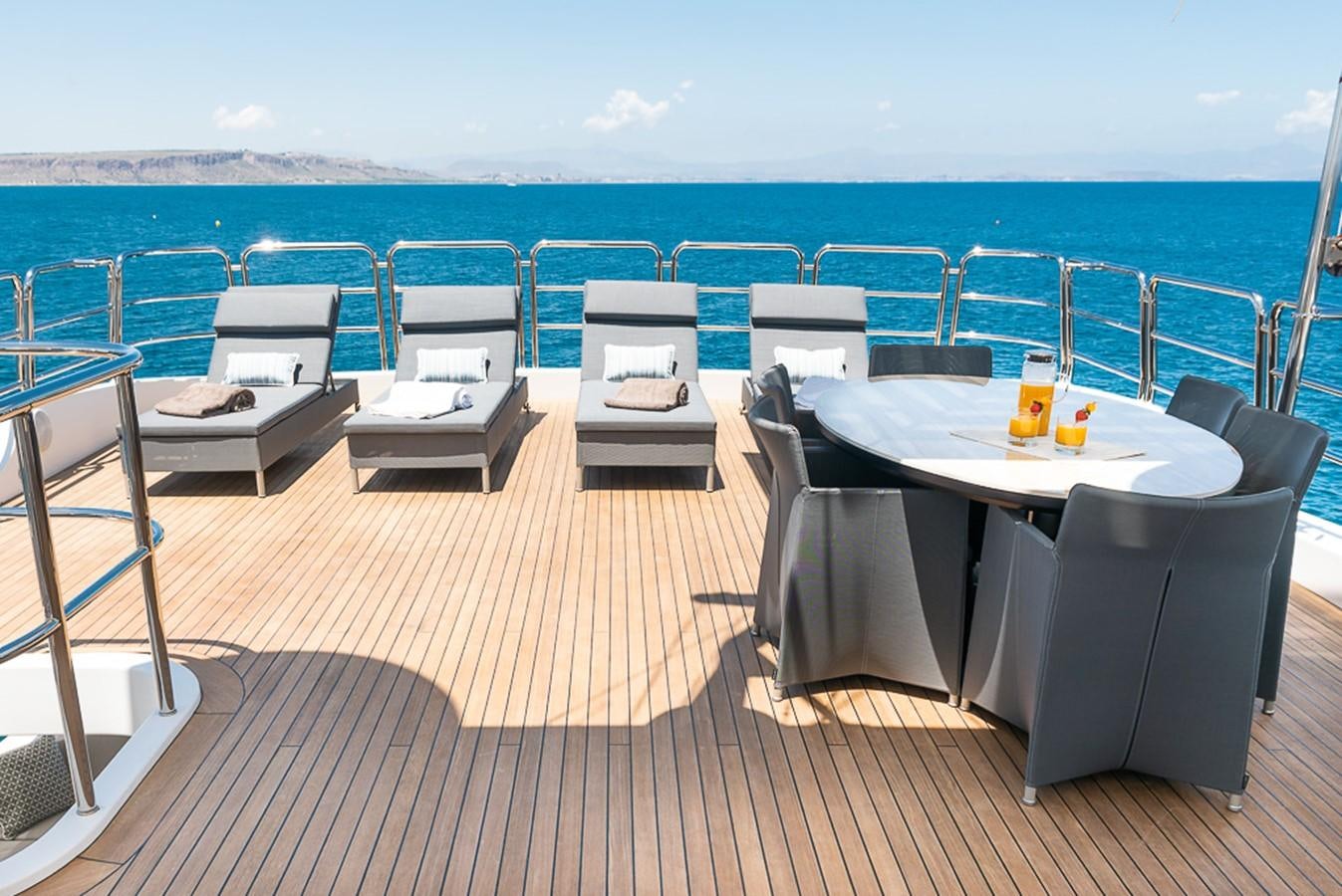 a deck with chairs and tables on it aboard ELENA NUEVE Yacht for Charter