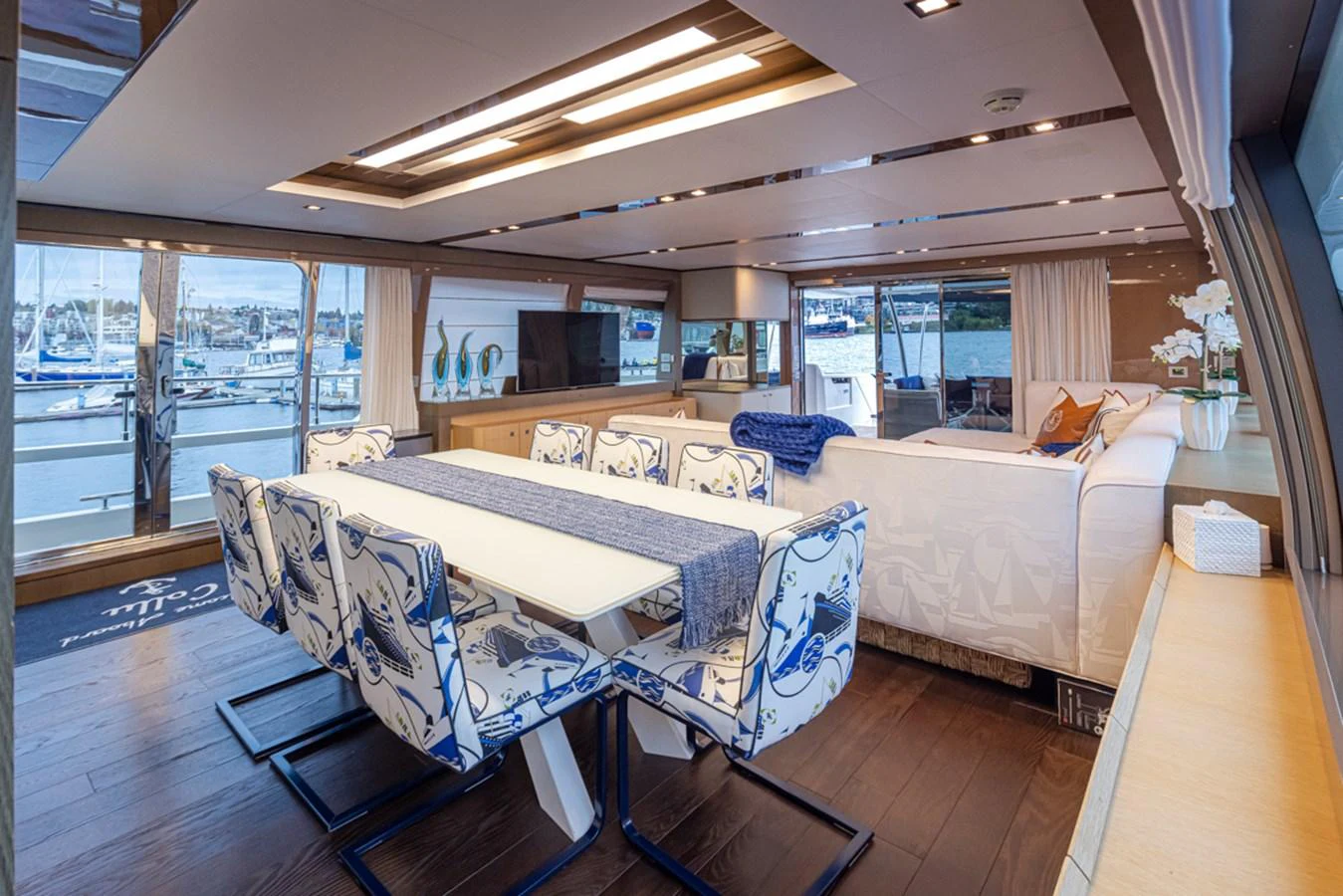 a large room with a table and chairs aboard SOL SHINE Yacht for Sale