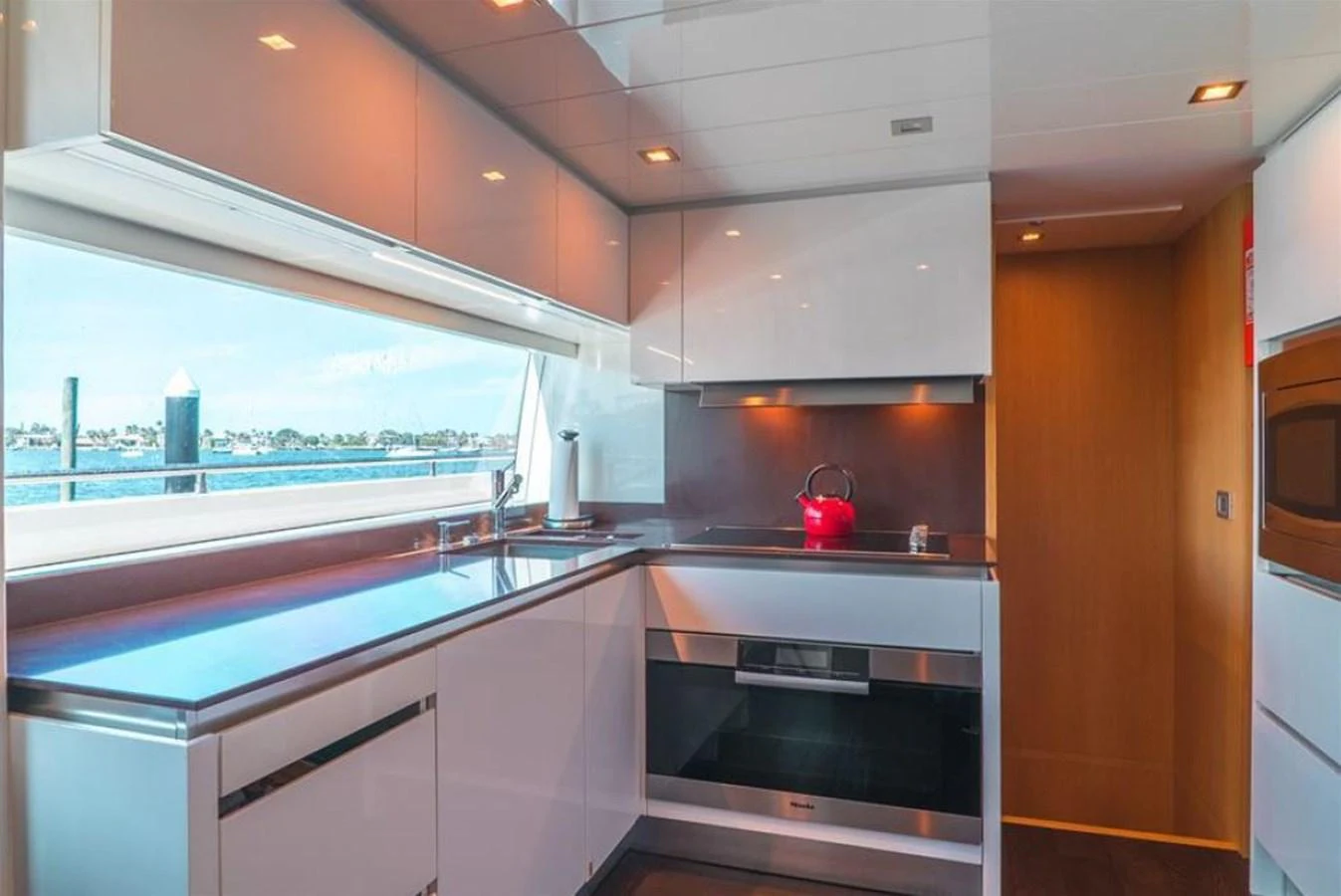 a kitchen with a glass door aboard SOL SHINE Yacht for Sale