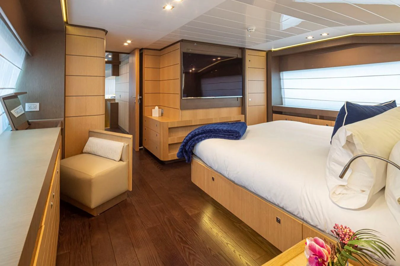 a bedroom with a bed and a chair aboard SOL SHINE Yacht for Sale