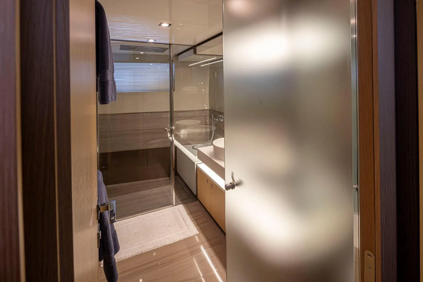 a bathroom with a glass shower aboard SOL SHINE Yacht for Sale