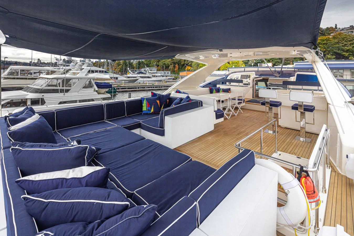 a deck with a deck and a view of the water and boats aboard SOL SHINE Yacht for Sale