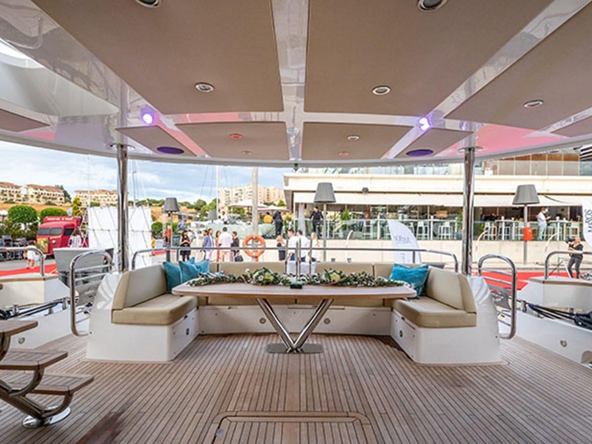 a large room with a table and chairs aboard 28M Yacht for Sale