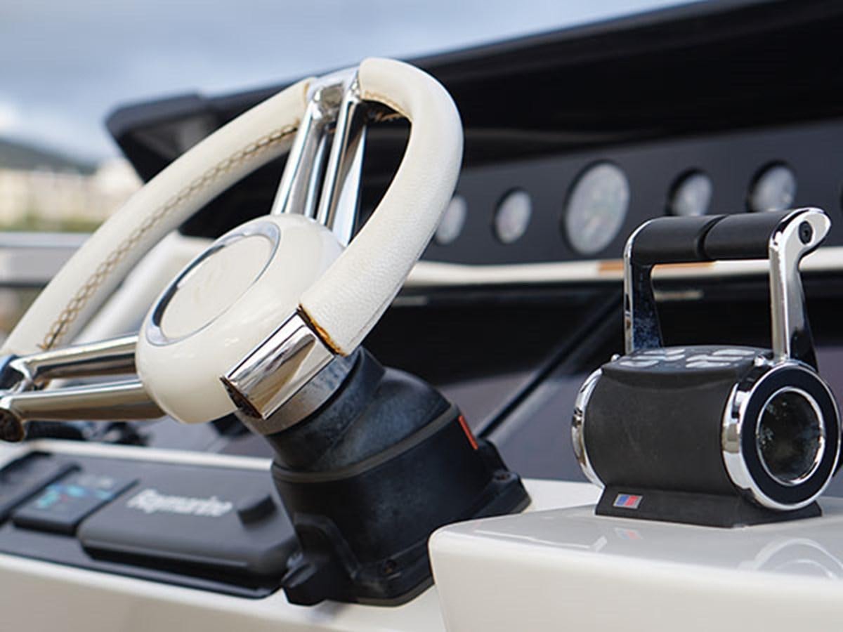 a pair of headphones on a car dashboard aboard 28M Yacht for Sale