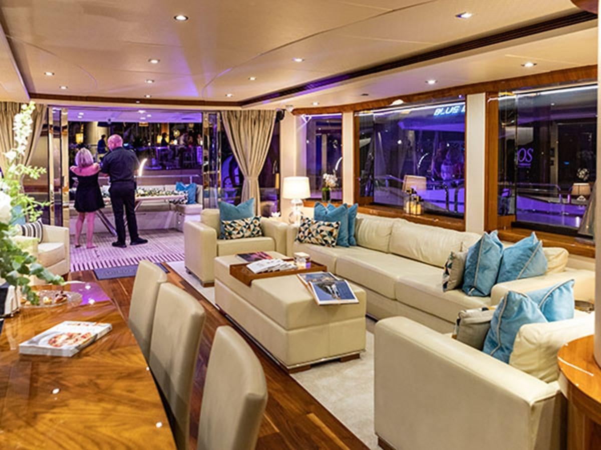 a living room with a couch and a table aboard 28M Yacht for Sale