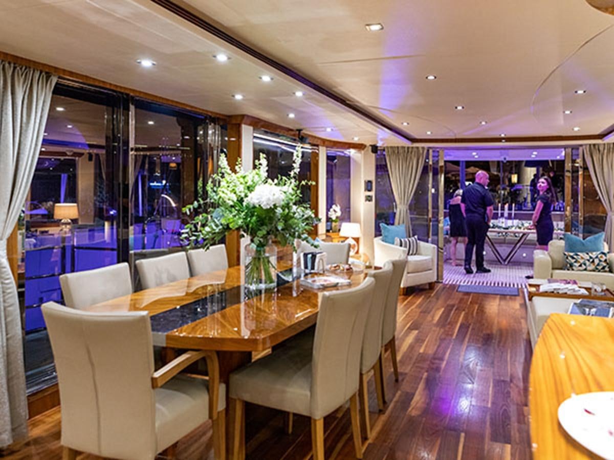 a room with tables and chairs aboard 28M Yacht for Sale
