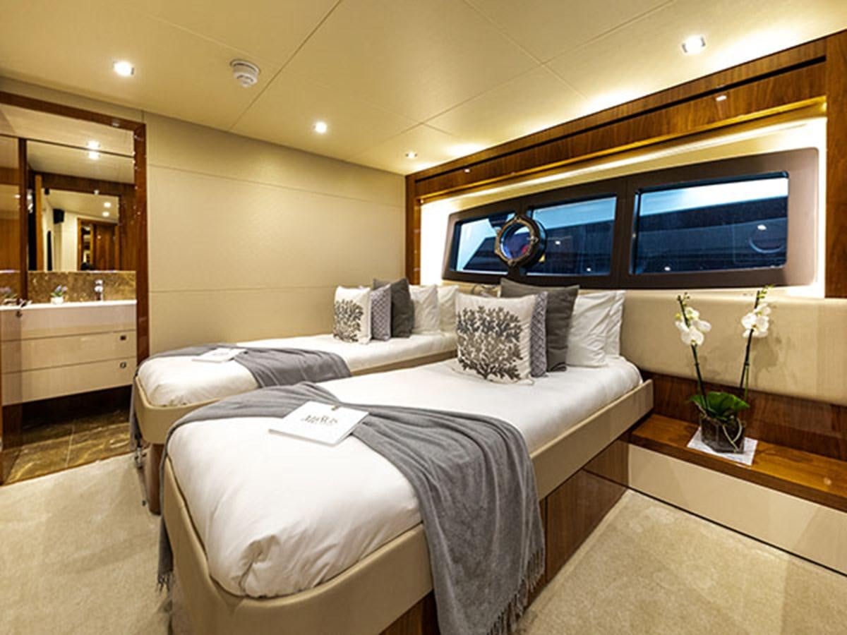 a bed with a white bed spread aboard 28M Yacht for Sale