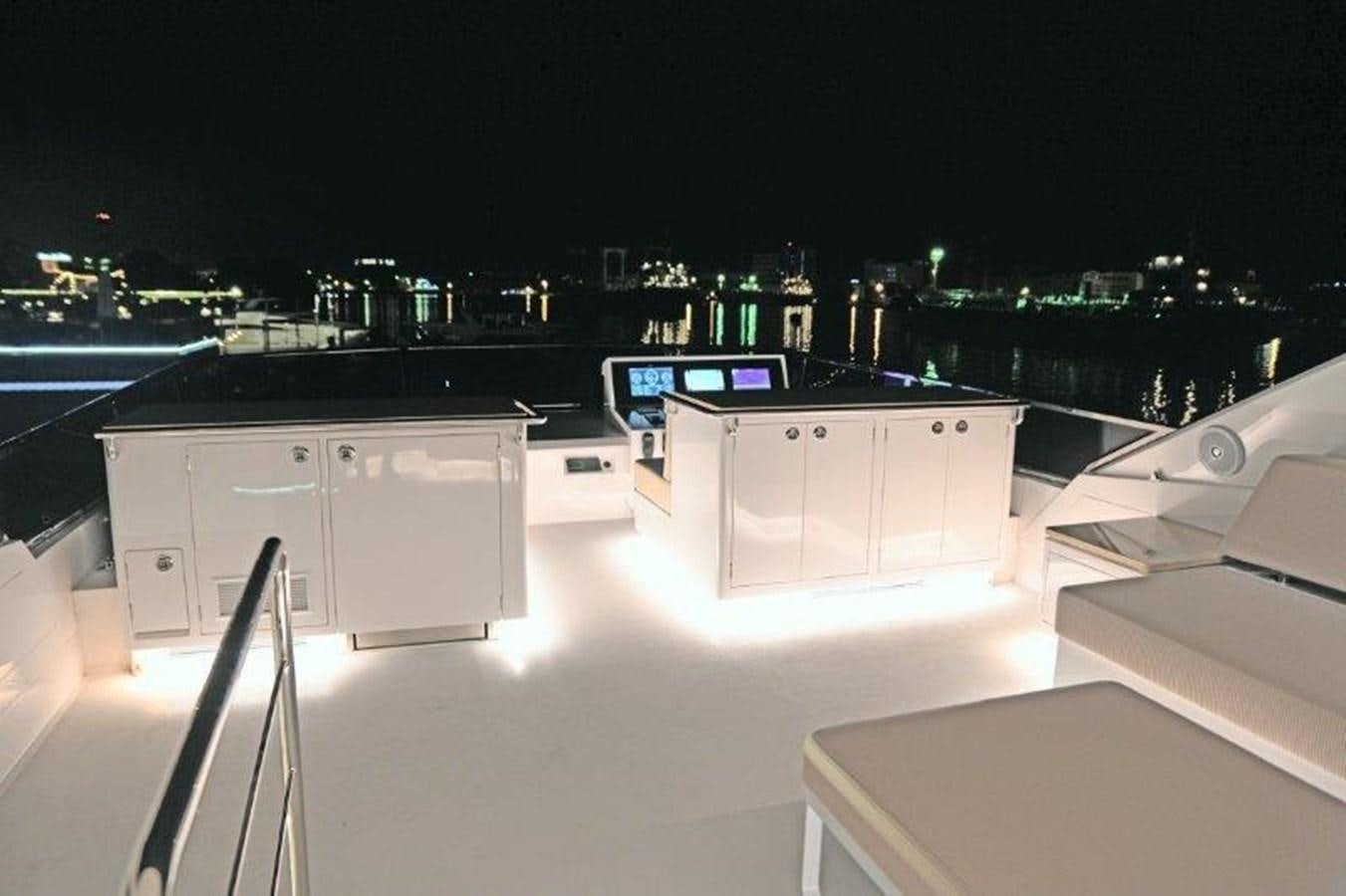 a large room with a large bar and a table with chairs aboard CROWNED EAGLE Yacht for Sale