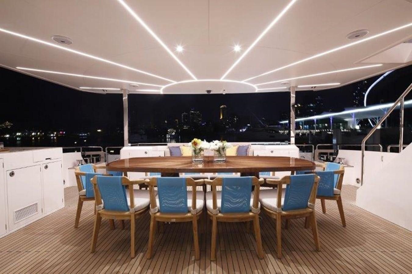 a large room with a table and chairs aboard CROWNED EAGLE Yacht for Sale