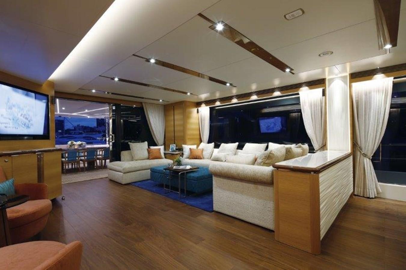 a living room with a large screen aboard CROWNED EAGLE Yacht for Sale