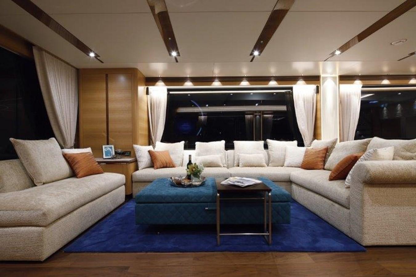 a living room with a blue rug aboard CROWNED EAGLE Yacht for Sale
