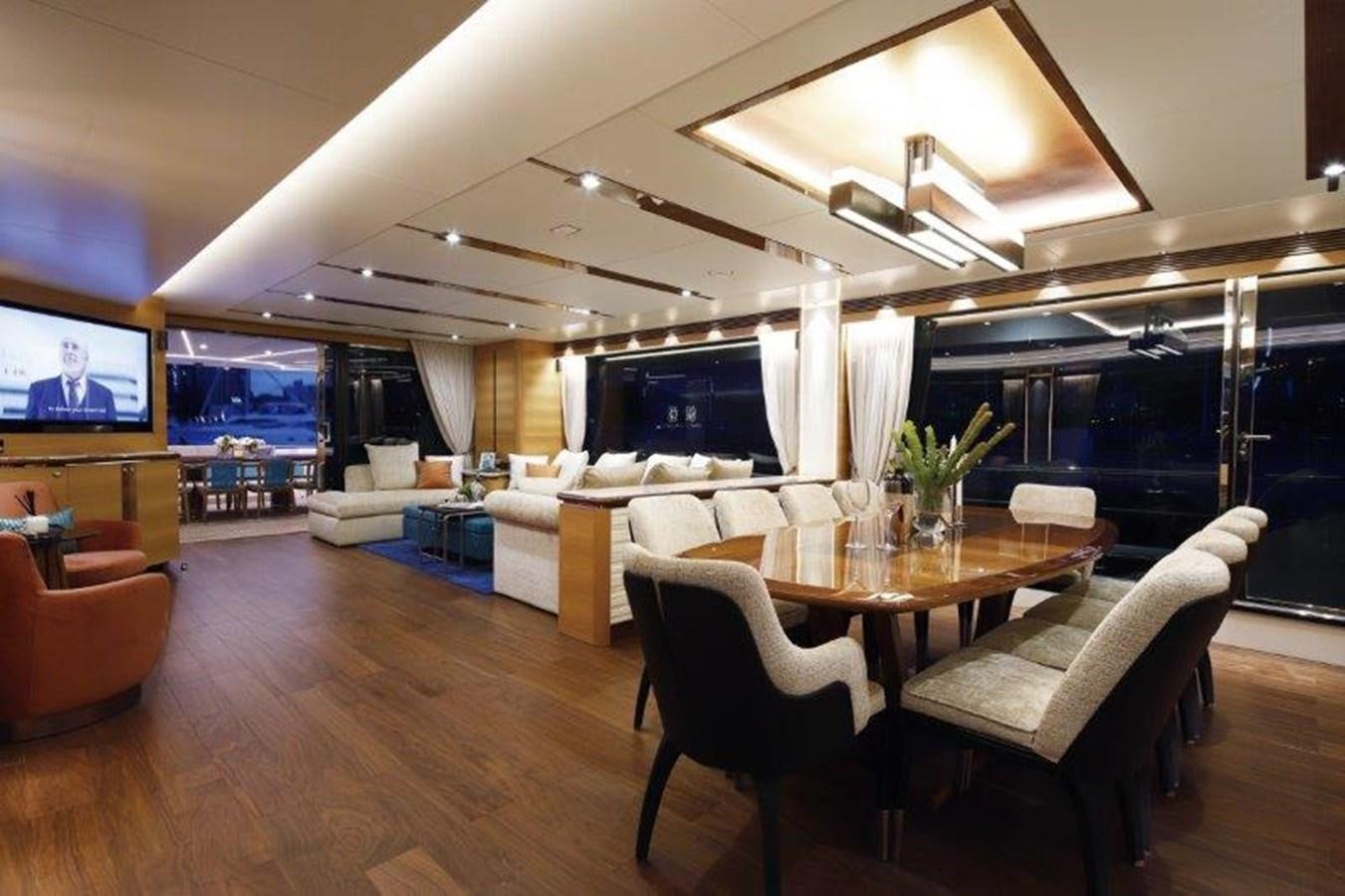 a living room with a table and chairs aboard CROWNED EAGLE Yacht for Sale