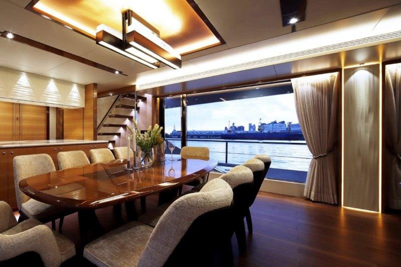 a room with a table chairs and a view of the water aboard CROWNED EAGLE Yacht for Sale