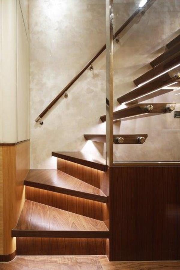 a wooden staircase with a metal railing aboard CROWNED EAGLE Yacht for Sale