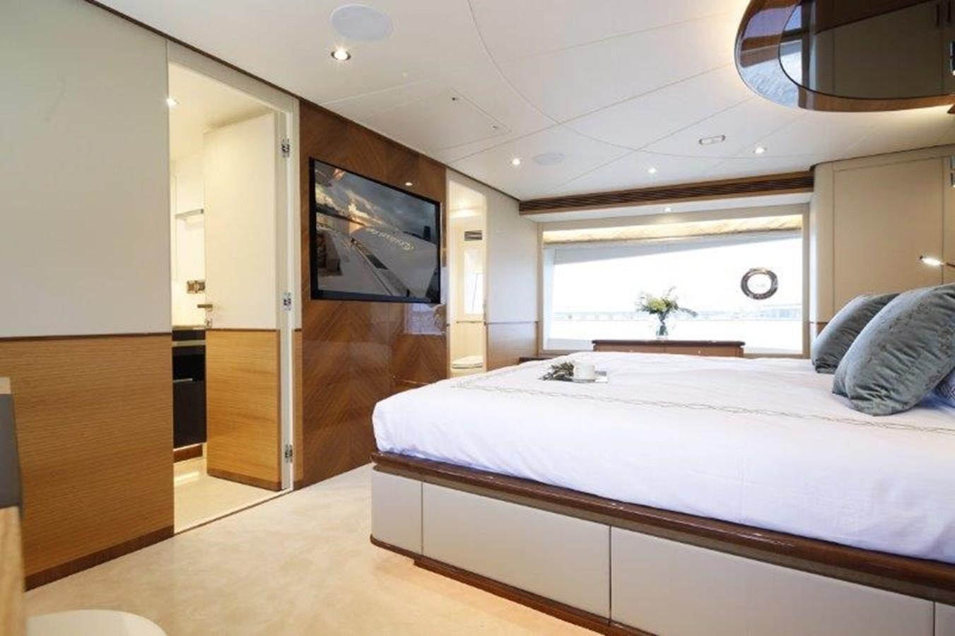 a bedroom with a bed and a tv aboard CROWNED EAGLE Yacht for Sale