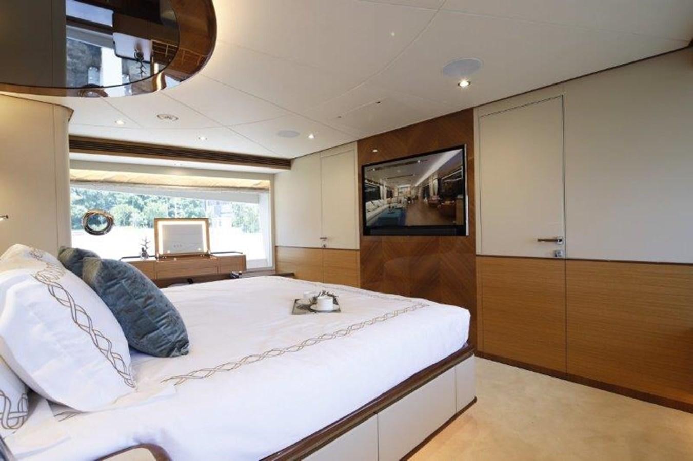 a bedroom with a bed and a tv aboard CROWNED EAGLE Yacht for Sale