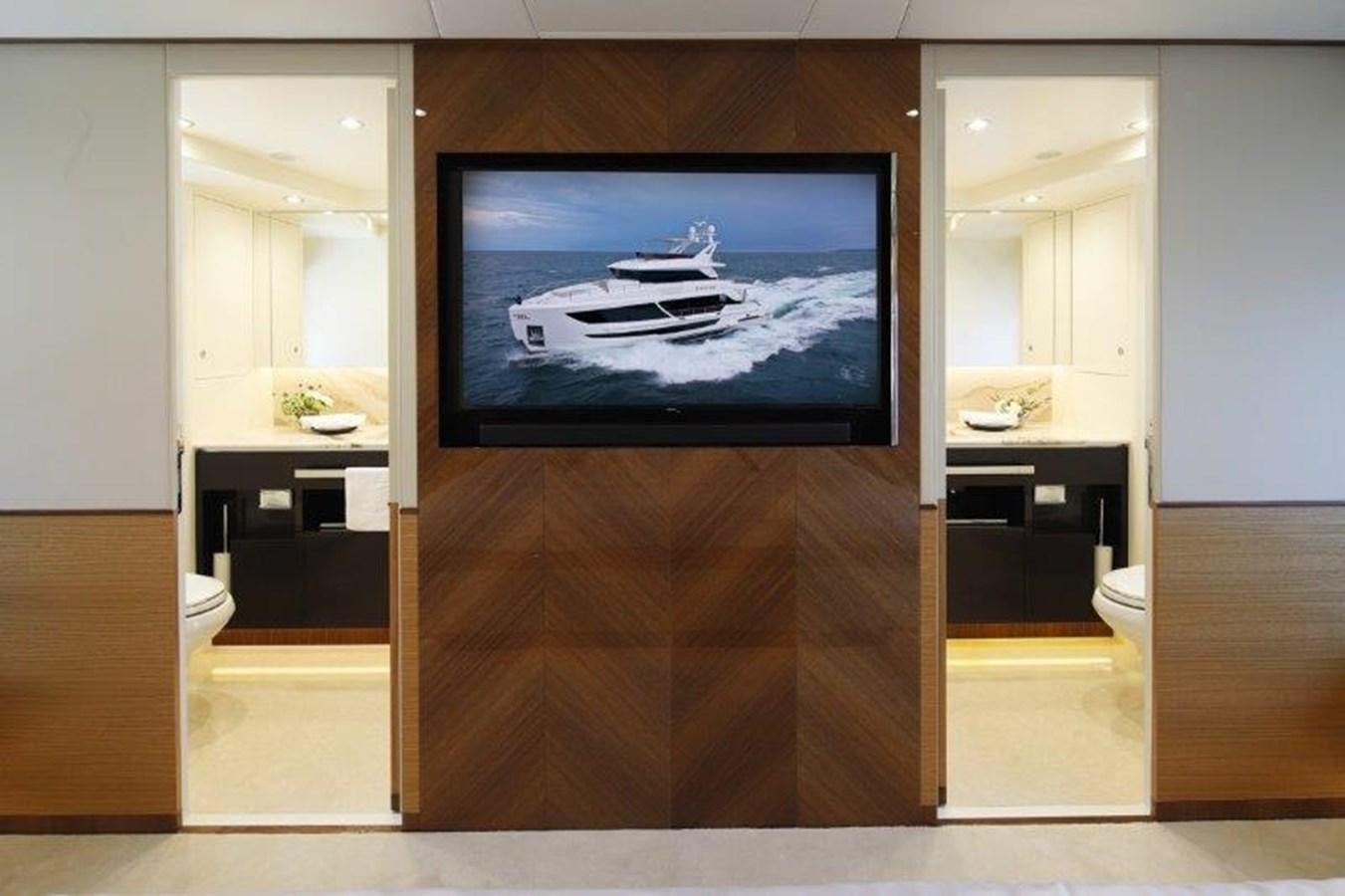 a room with a tv on the wall aboard CROWNED EAGLE Yacht for Sale