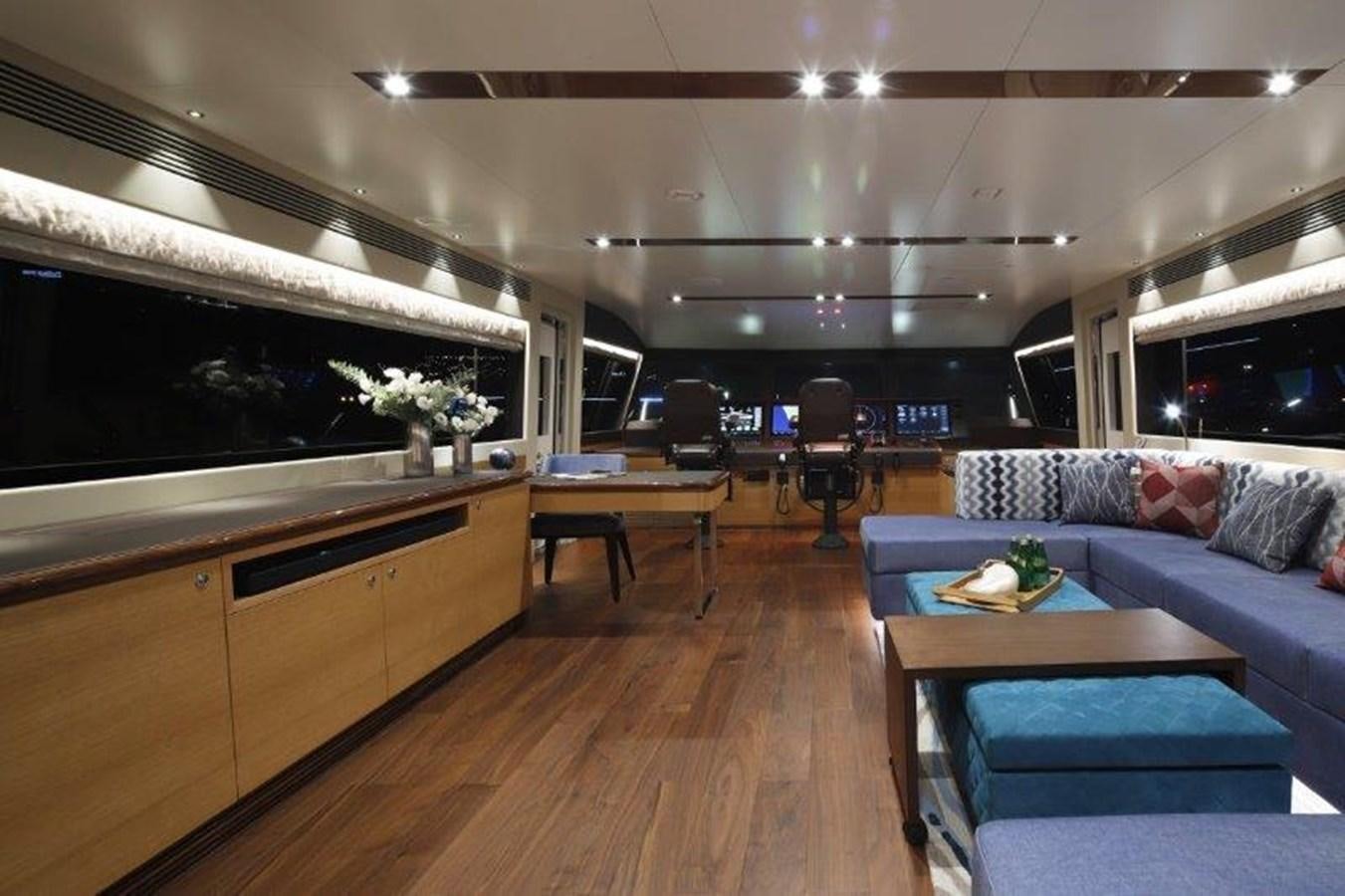 a room with a couch and a table and a tv aboard CROWNED EAGLE Yacht for Sale