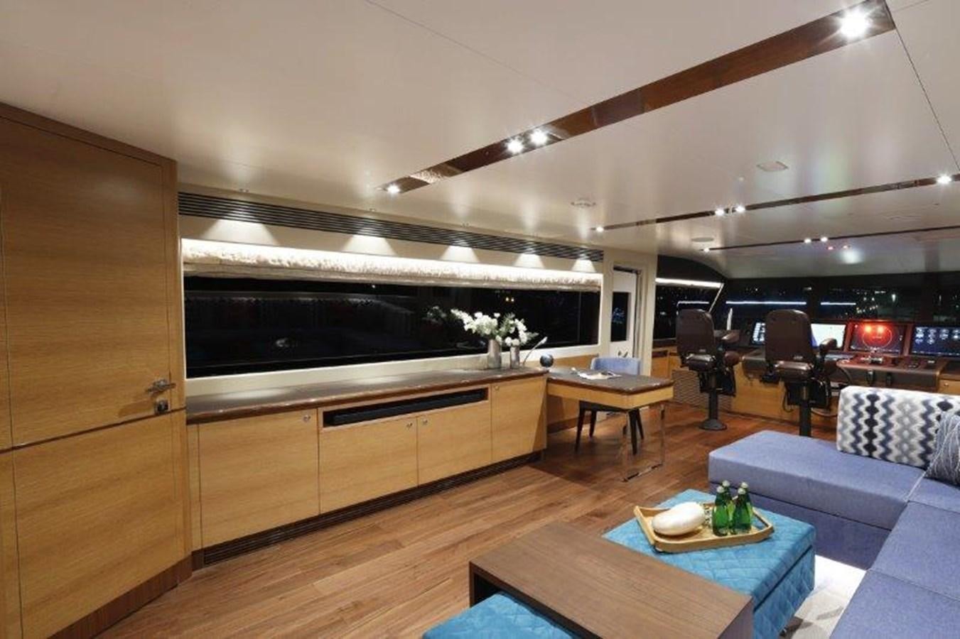 a room with a couch and a table and a chair aboard CROWNED EAGLE Yacht for Sale
