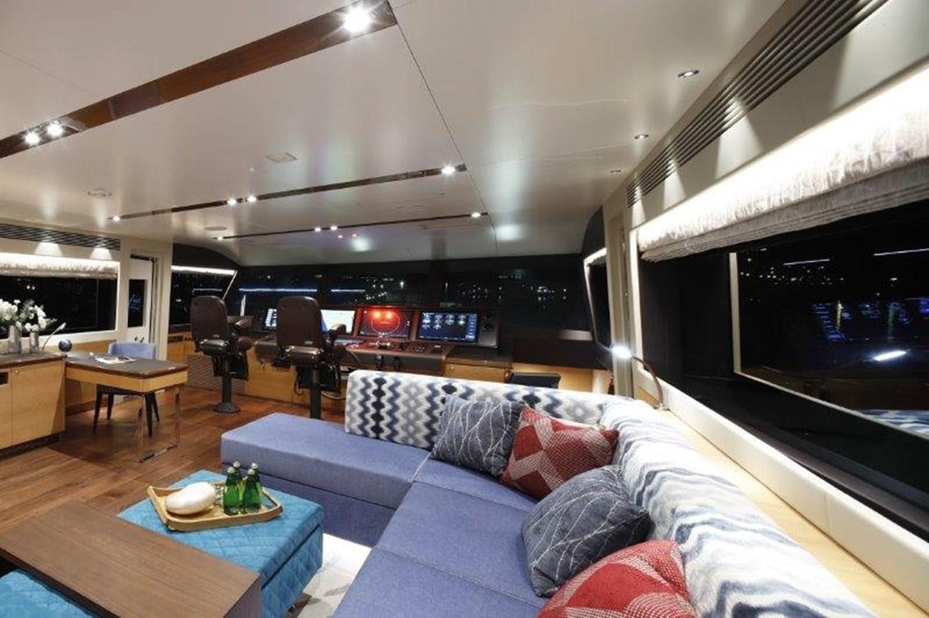 a living room with a couch and a table aboard CROWNED EAGLE Yacht for Sale