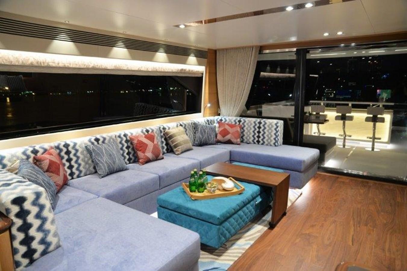 a living room with a couch and a table aboard CROWNED EAGLE Yacht for Sale