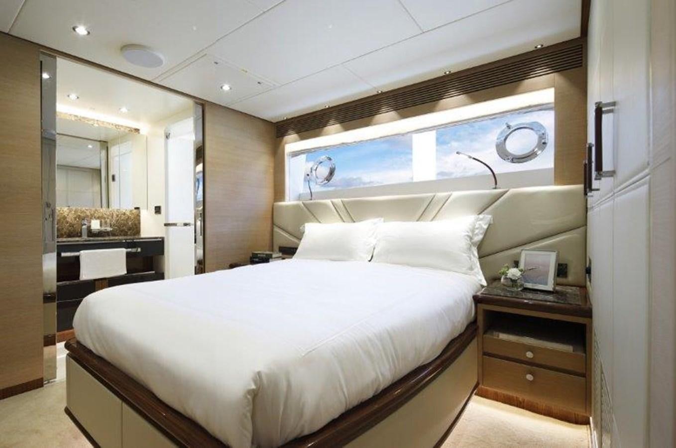 a bedroom with a bed and a desk aboard CROWNED EAGLE Yacht for Sale