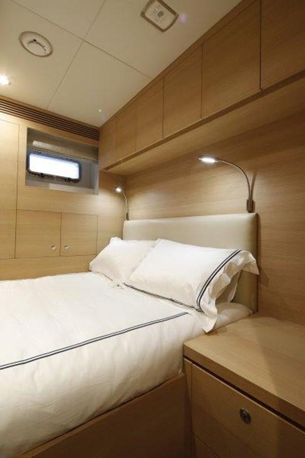 a bed with white sheets aboard CROWNED EAGLE Yacht for Sale