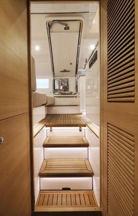 a hallway with a mirror and a bed aboard CROWNED EAGLE Yacht for Sale