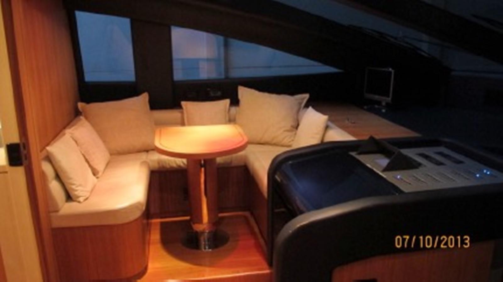 a room with a couch and a table with a laptop on it aboard SPYRO Yacht for Sale