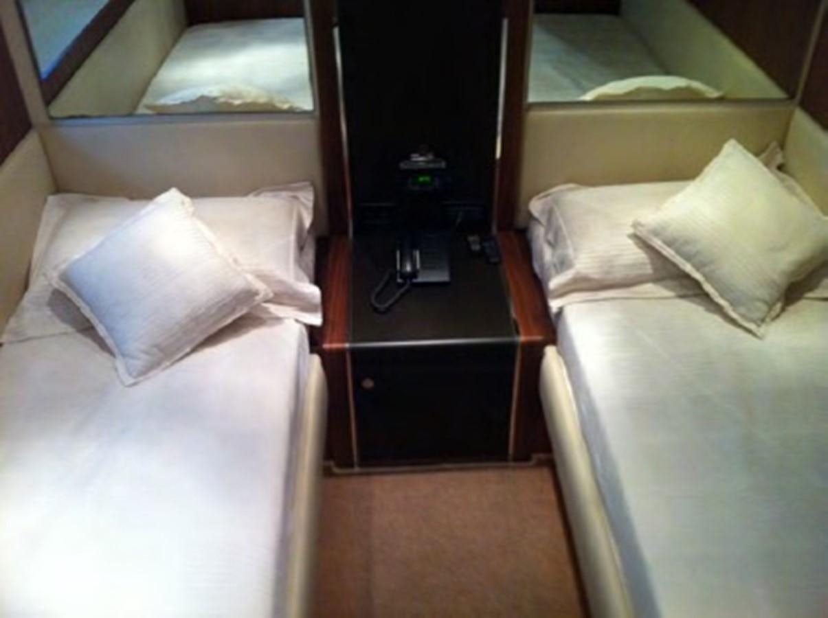 a room with a bed and a television aboard SPYRO Yacht for Sale