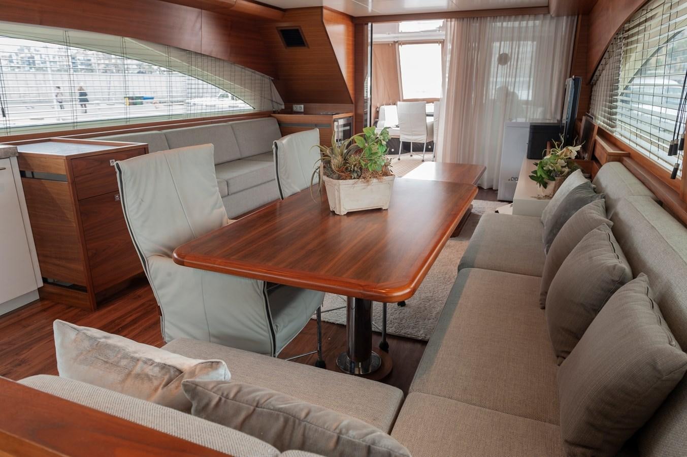 a living room with a table and couches aboard ANGELS Yacht for Sale