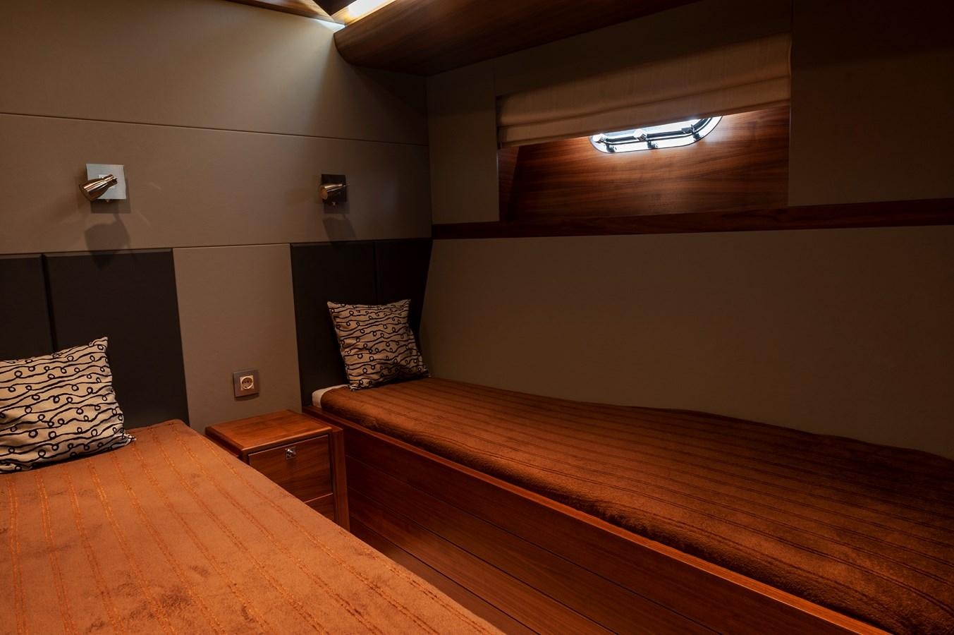 a room with a bed and a table aboard ANGELS Yacht for Sale