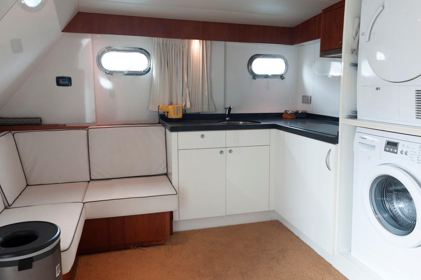a small kitchen with white cabinets aboard ANGELS Yacht for Sale