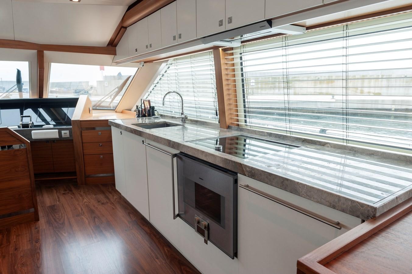a kitchen with white cabinets aboard ANGELS Yacht for Sale