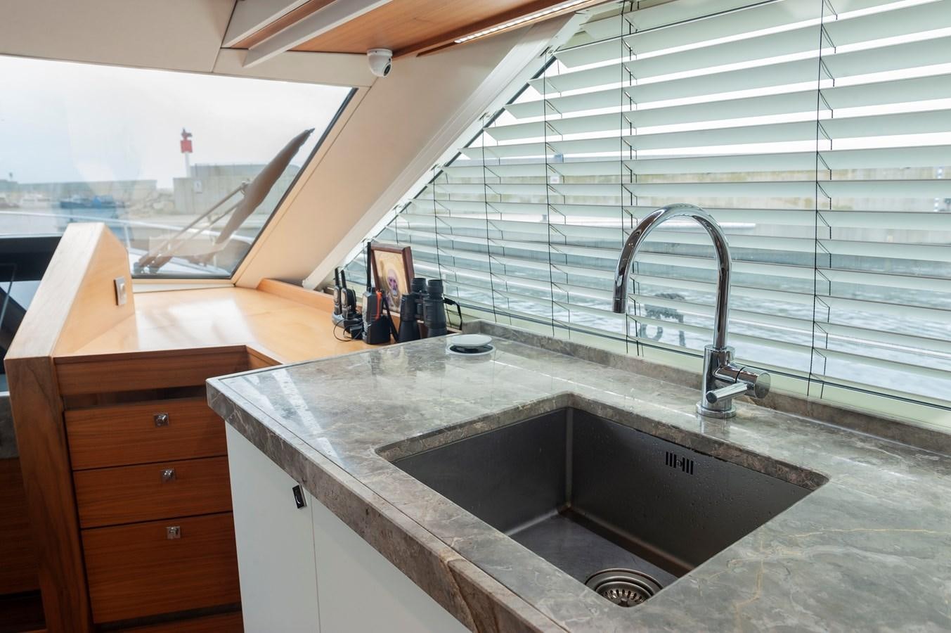 a bathroom with a sink and a large window aboard ANGELS Yacht for Sale