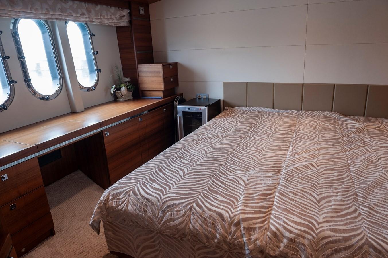a bedroom with a bed and a window aboard ANGELS Yacht for Sale