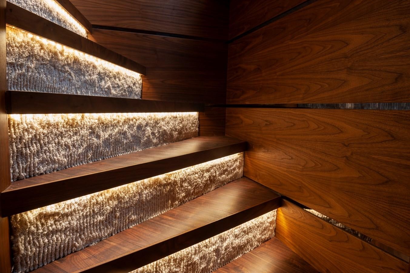 a wooden staircase with a railing aboard ANGELS Yacht for Sale