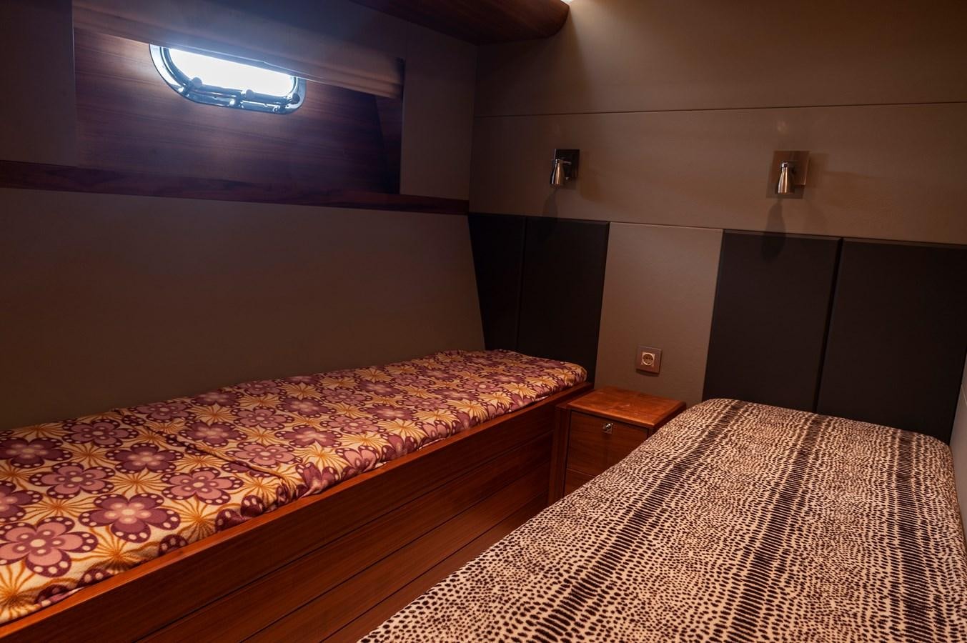 a bedroom with a bed and a dresser aboard ANGELS Yacht for Sale