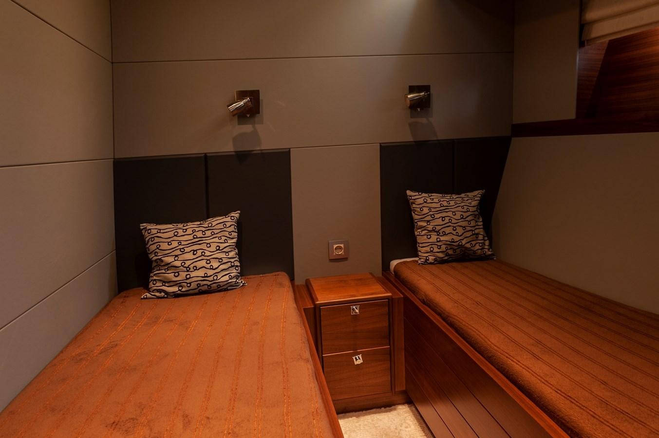 a room with a bed and a dresser aboard ANGELS Yacht for Sale
