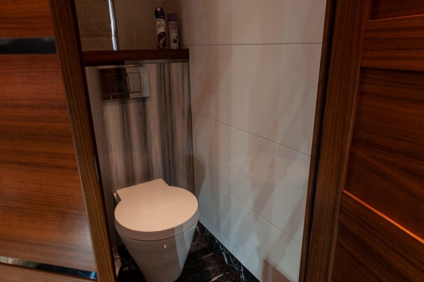 a toilet next to a shower aboard ANGELS Yacht for Sale