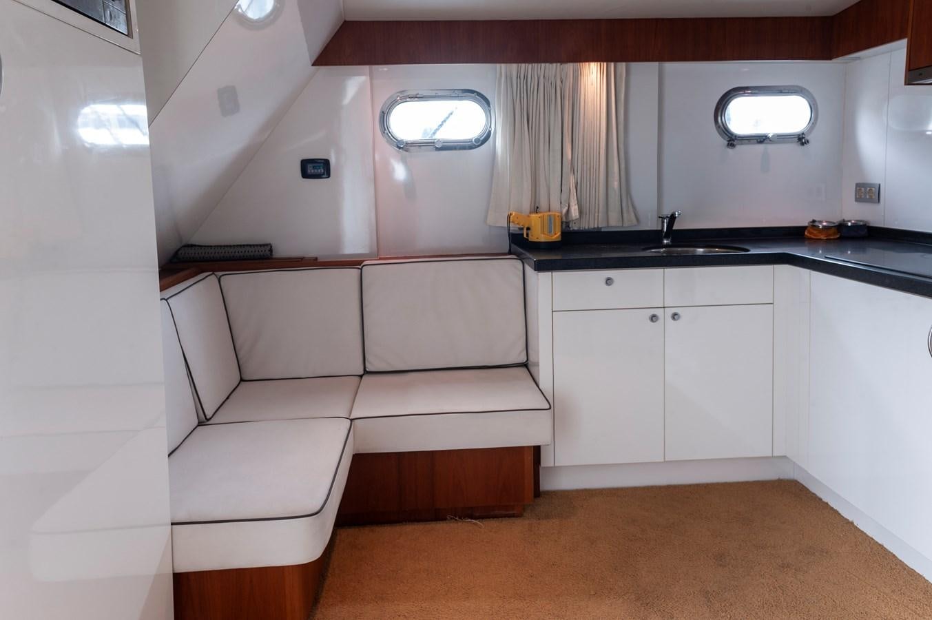 a room with a white couch and a sink aboard ANGELS Yacht for Sale
