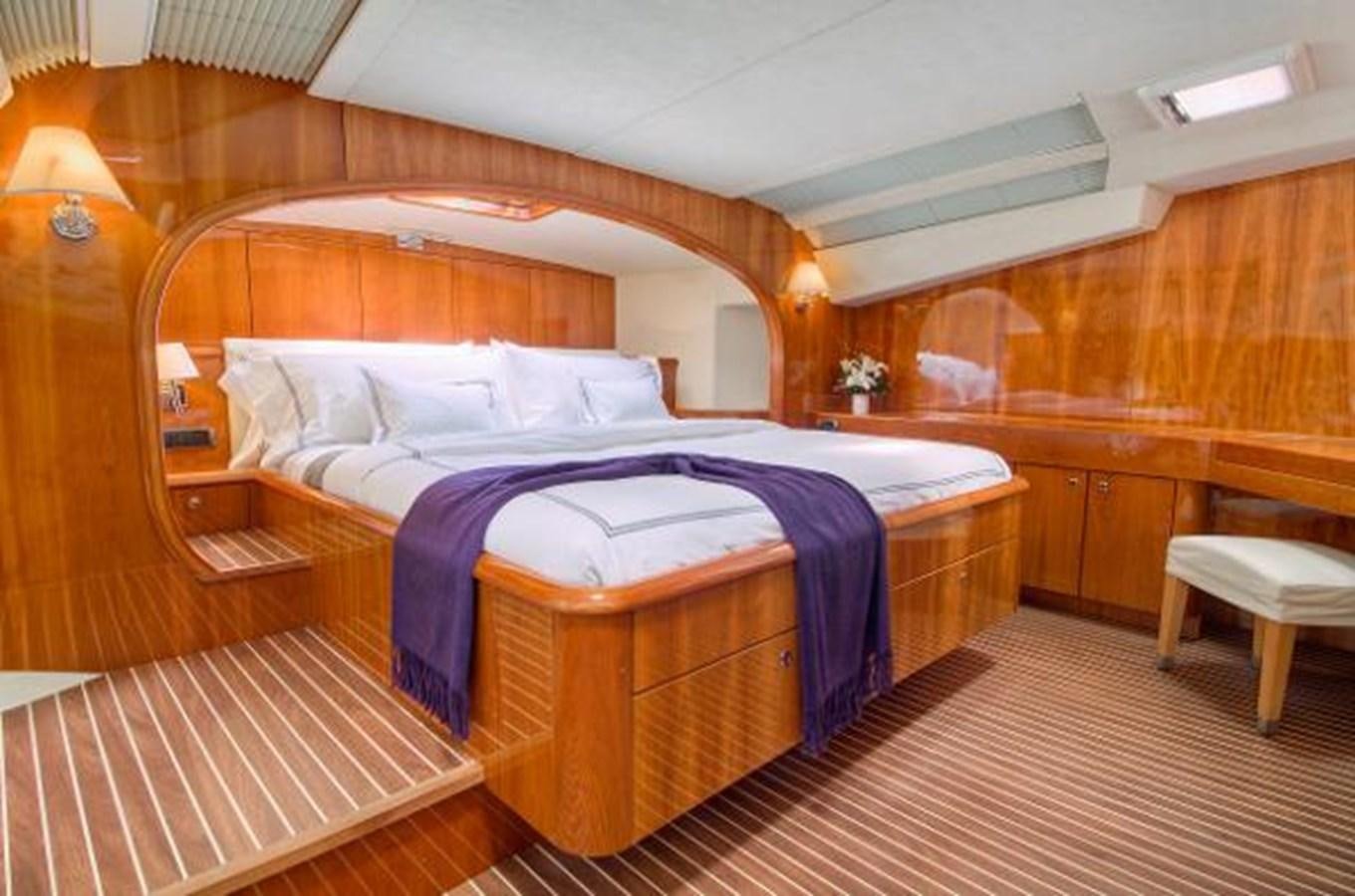 a room with a bed and a table aboard 74' PRIVILEGE 2010 Yacht for Sale
