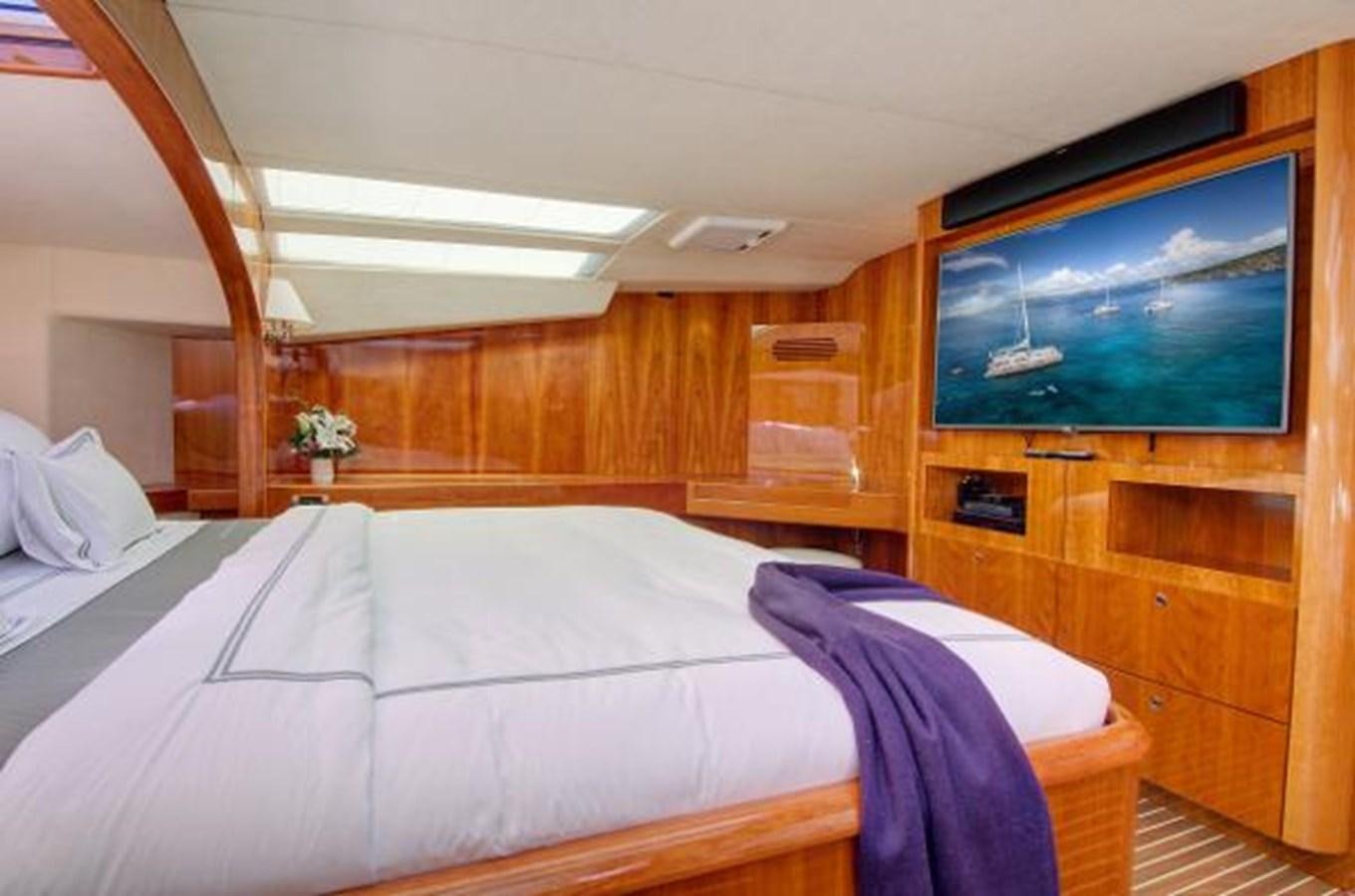 a room with a bed and a television aboard 74' PRIVILEGE 2010 Yacht for Sale