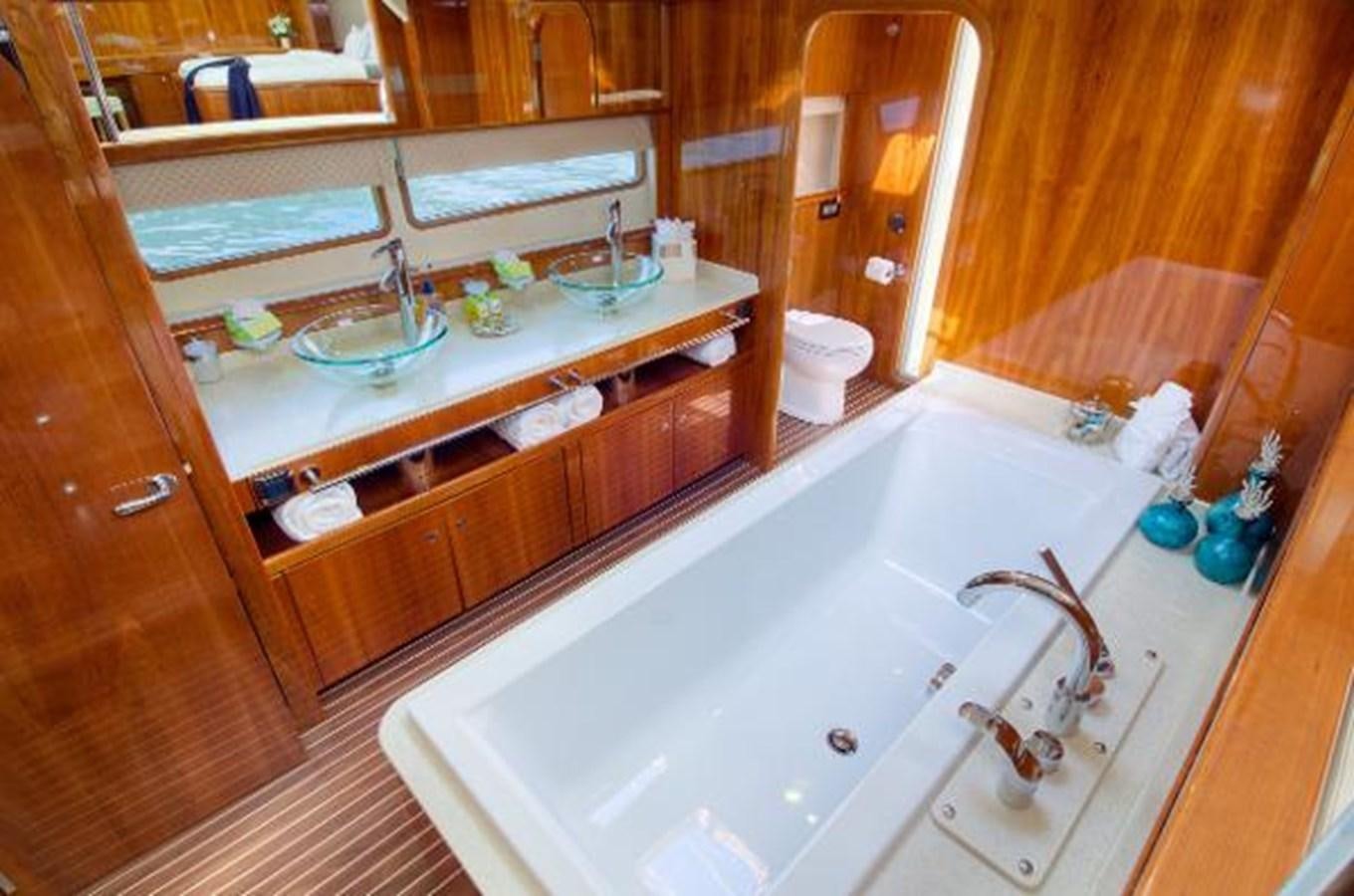 a bathroom with a tub sink and toilet aboard 74' PRIVILEGE 2010 Yacht for Sale