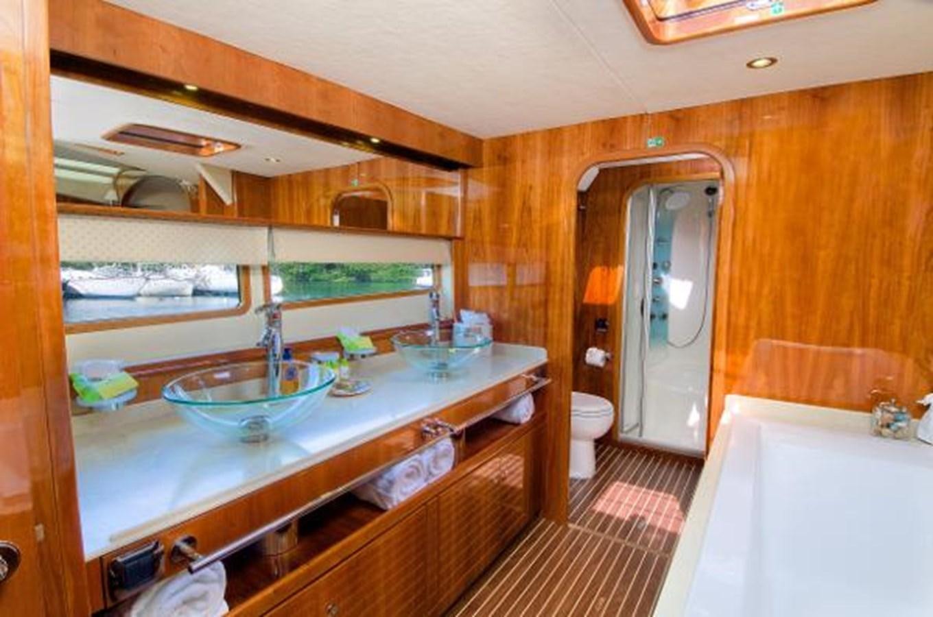 a bathroom with a sink and tub aboard 74' PRIVILEGE 2010 Yacht for Sale